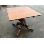 A nineteenth century mahogany breakfast table, the square top supported on bulbous turned column