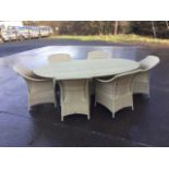 A large Dedon faux cane dining table & chair set, the oval table having plate glass top with six