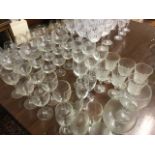 A collection of drinking glasses, all in sets - brandy balloons, wine glasses, flutes, Irish with