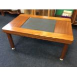 A 1970 teak hi-fi table, with adjustable square moulded column legs supporting thick rectangular