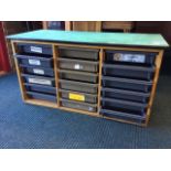 A cabinet of 18 sliding tray drawers from a school, with rectangular painted worktop. (42in x 19in x