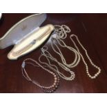 A cased Lotus twin-strand choker necklace; and five other pearl style necklaces. (6)