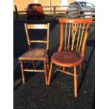 An oak bedroom chair with spindleback above a circular upholstered seat with brass studding,