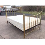 An Edwardian brass double bed, the headboard and tailboard with concave moulded rails on square