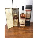 Glen Moray, a tinned bottle of single highland malt whisky; and cased bottle of Glenmorangie
