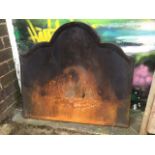 A plain cast iron fireback with arched scalloped moulded frame. (30in x 27in)