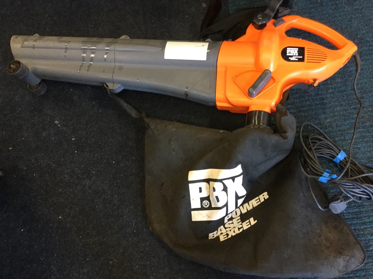 A Power Base excel 2400 watt electric garden blower/vac, with long cable and leaf collecting bag.