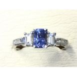 An 18ct gold tanzanite & diamond ring, the radiant cut tanzanite framed by baguette cut diamonds,