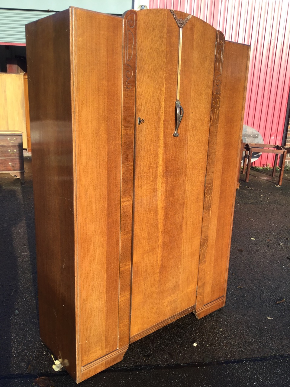 An oak wardrobe by Lawrencia, having arched door with press moulded floral decoration mounted with - Image 2 of 3