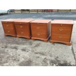 Two pairs of mahogany bedside cabinets by Stag, each with moulded tops above slides and two