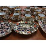 A Royal Crown Derby 18-piece teaset decorated in the traditional blue, gilt and brick red palette,