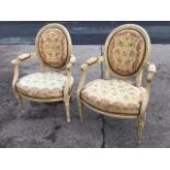 A pair of painted fauteuils with oval moulded backs, the floral tapestry upholstery with brass