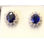 A pair of 18ct gold sapphire & diamond earrings, the oval claw set sapphires weighing just under