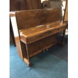 A 1930s walnut upright piano by Rogers Eungblut, with rounded case and seven octave keyboard