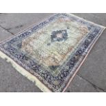 An oriental style chenille rug woven with central ink blue lozenge and pendants on busy floral