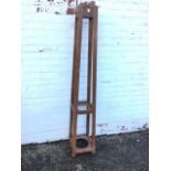 A square mahogany hatstand mounted with pegs, having angled rectangular legs joined by two platforms