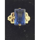 A large sapphire ring on 9ct gold band, the emerald cut sapphire of nearly two carats, the stone