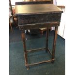 A Victorian pine clerks desk, the top with cleated hinged lid on later stand, with square column