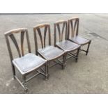 A set of for oak dining chairs, the backs with twin flared splats beneath shaped carved rails,