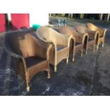 A set of five Lloyd Loom Lusty armchairs, the rounded backs with lozenge panels having flared arms