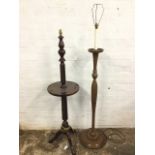 A mahogany standard lamp with twisted turned column having mid-tier circular platform, raised on