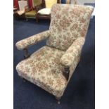 A late Victorian upholstered oak armchair, with floral tapestry covering, having padded back and