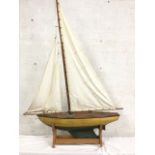 A large Edwardian pond yacht, the oak decked vessel with brass mounts having painted hull with