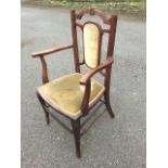 An Edwardian art nouveau style armchair having back with rectangular tapering rounded upholstered