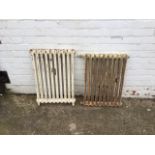 Two slim cast iron radiators, the largest freestanding on shaped feet - 21in x 30in & 19.5in x 28in.