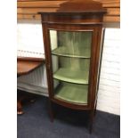 An Edwardian bowfronted mahogany boxwood strung display cabinet, having arched upstand to top
