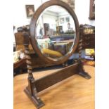 A George VI oak dressing table mirror, the circular bevelled plate supported on barleytwist