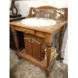 A Victorian style pine vanity unit, having oval basin mounted with Adams brass taps, the washstand