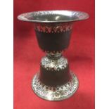 An antique iron vase, the base and bowl of bell shape united by cushion band, decorated with