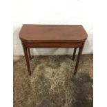 A nineteenth century mahogany turn-over-top tea table, the rounded twin leaves and frieze inlaid