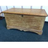 A Victorian dovetailed pine blanket box, the plinth with shaped apron, having interior with