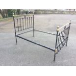 A Victorian brass & iron bed, the headboard & tailboard with vertical grill panels having circular
