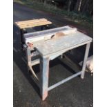 A German electric saw bench with galvanised tabletop raised on angled legs; and a folding workmate