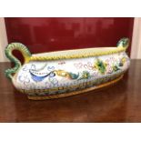 A handpainted Portuguese flower trough of oval bulbous form mounted with snake style handles,