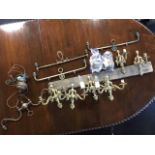 A set of six brass wall sconces with scrolled brackets and urn cast wallplates - four twins and