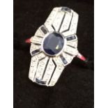 An art deco Egyptian style 9ct white gold sapphire & diamond ring, the panel with oval bezel set
