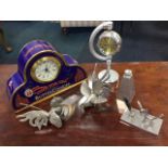 A pair of silver plated fighting cockerels, a clock biscuit tin, a pewter flask, an electric clock