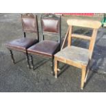 A pair of late Victorian dining chairs with leaf carved backs above upholstered panels, having