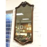 A Queen Anne style mahogany framed mirror, with pierced scrolled crest and cushion moulded