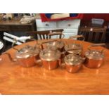 A collection of six Victorian copper kettles with riveted swan neck handles, oval & circular. (6)