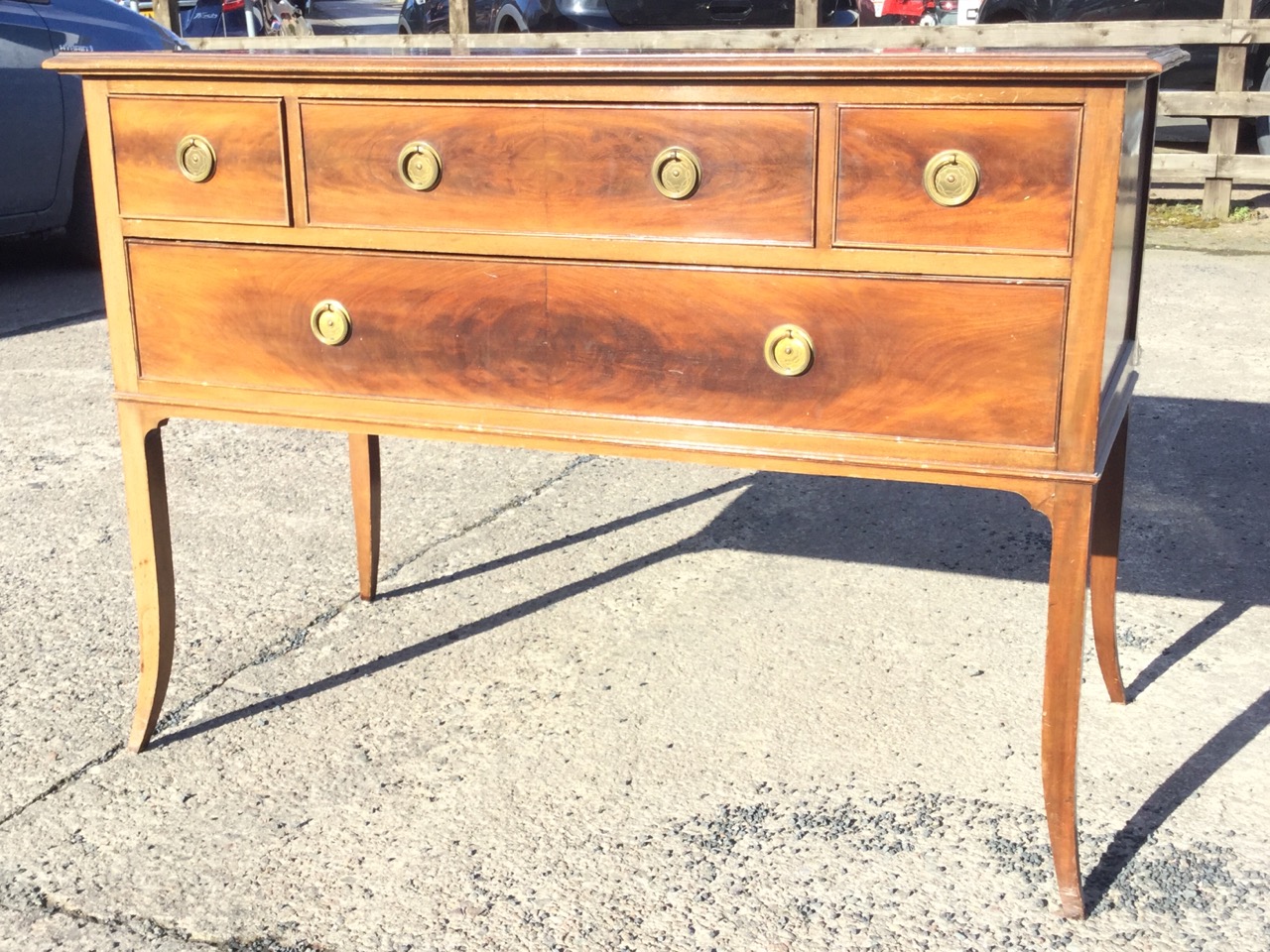 An Edwardian mahogany dressing table with rectangular moulded top above three cockbeaded drawers and