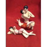 A large deco style porcelain pincushion dolly modelled as a young couple; and a pair of