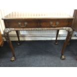 A mahogany serving table, with rectangular moulded top above two frieze drawers and gadroon carved