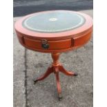 A circular reproduction lamp table with gilt tooled leather skiver to ribbed drum top having two