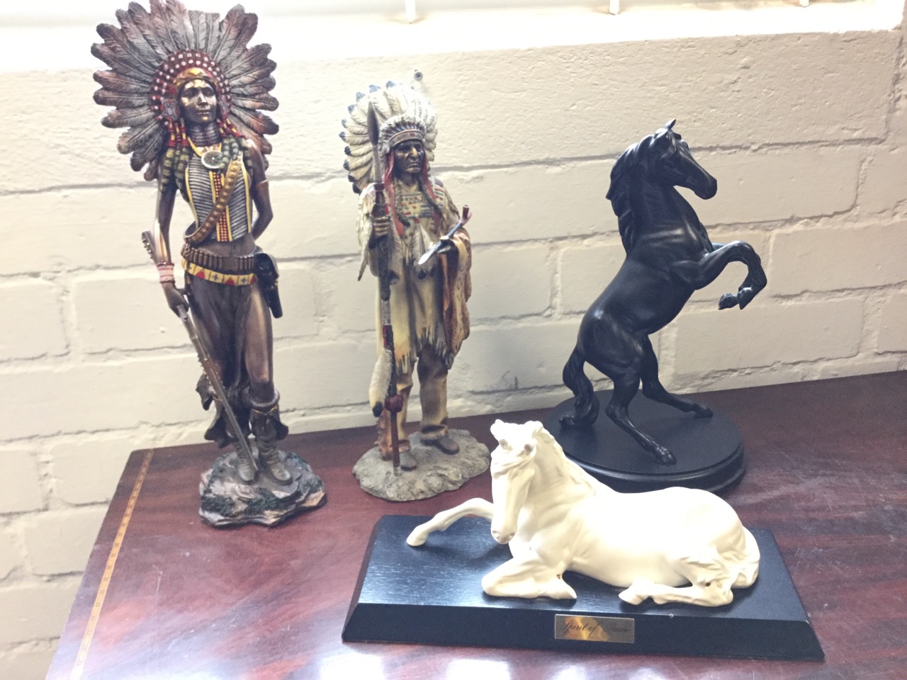 A Royal Doulton cast of a rearing horse on circular plinth; two resin cast Indian figures -