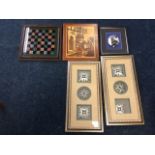 A pair of decorative carved silvered medallions in ribbed frames; a Victorian painted chessboard